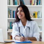 A naturopathic doctor working at a laptop