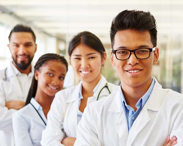 Naturopathic medicine students wearing lab coats